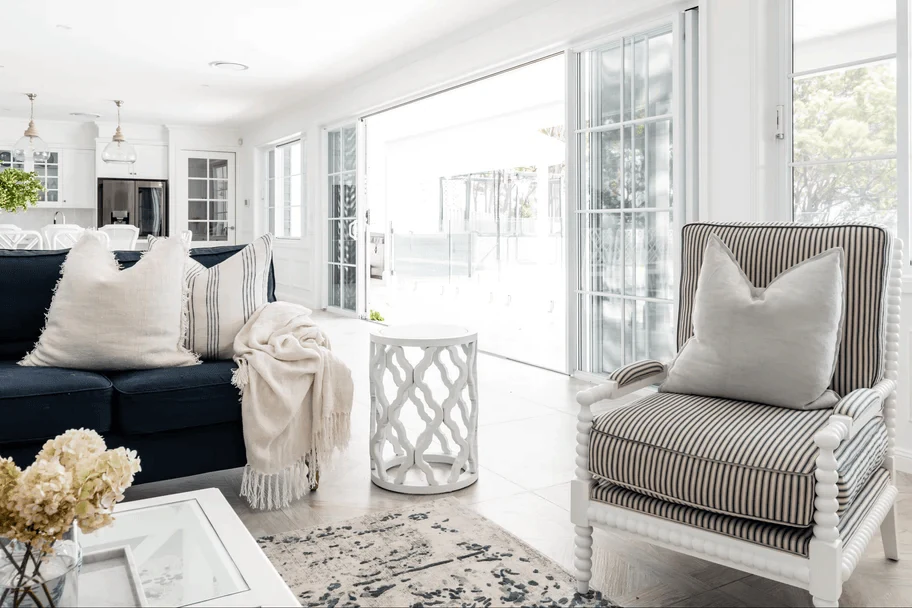 Hampton interior design style living room with white panelling and coastal light