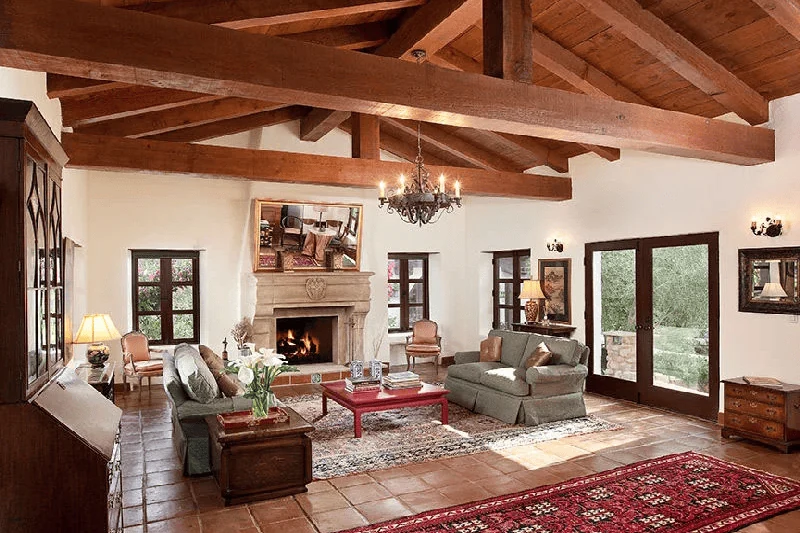 Spanish interior design style living room with terracotta floor and timber trusses