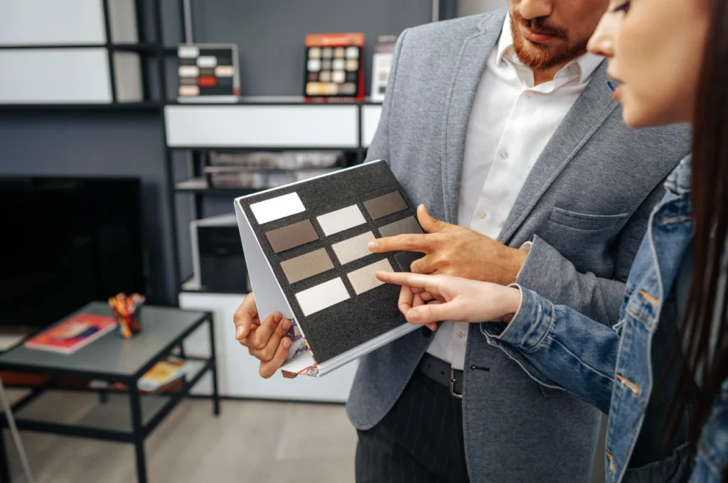 Designer showing material samples to a client during turnkey fit out project management in Dubai